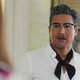Mario Lopez as Harland Sanders, looking shocked to see Jessica